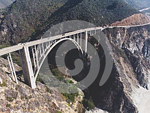 Aerial panoramic view of historic Bixby Creek Bridge along world famous Pacific Coast Highway 1 in summer sunny day , Monterey