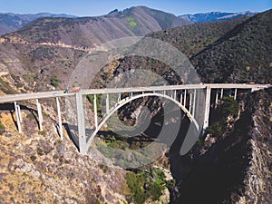 Aerial panoramic view of historic Bixby Creek Bridge along world famous Pacific Coast Highway 1 in summer sunny day , Monterey