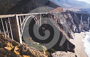 Aerial panoramic view of historic Bixby Creek Bridge along world famous Pacific Coast Highway 1 in summer sunny day , Monterey