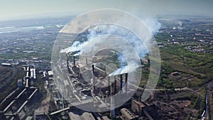 Aerial panoramic view of industrial zone with large factory pipes