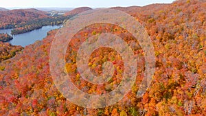 Aerial panoramic view of a lake and fall season foliage colors