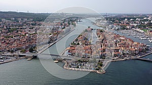 Aerial panoramic view of landscape of old town of Martigues on Mediterranean coast with scenic canals and marina on