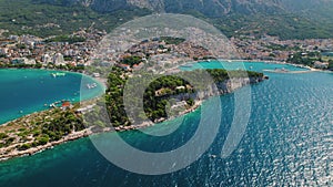 Aerial panoramic view of Makarska's Coastal Elegance. Bustling city against the placid sea. Popular tourist