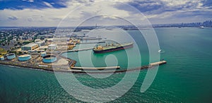 Aerial panoramic view of oil tanker and industrial wharfs.