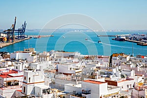Aerial panoramic view of the old city rooftops and Cathedral de Santa Cruz in the afternoon from tower Tavira in Cadiz