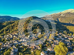 Aerial panoramic view over the picturesque village Papigo in Epirus, Greece at sunset. Scenic aerial view of traditional Greek