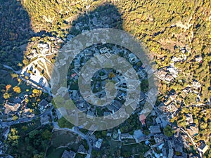 Aerial panoramic view over the picturesque village Papigo in Epirus, Greece at sunset. Scenic aerial view of traditional Greek