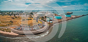 Aerial panoramic view of parking lot and industrial wharfs near ocean coastline at Williamstown suburb of Melbourne, Australia. photo