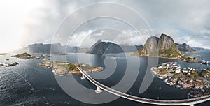 Aerial panoramic view of Reine traditional fishing village in the Lofoten archipelago in northen Norway with blue sea