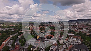 Aerial panoramic view of residential urban neighbourhood or suburb. Apartment houses surrounded by trees and green