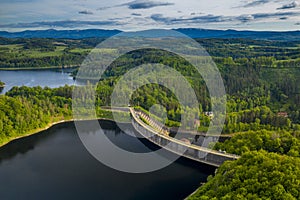 Aerial panoramic view of stone dam at reservoir near Karkonosze mountains. Dam and hydroelectric water power station