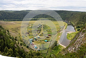 aerial panoramic view on summer forest, river and mountains Summer green valley landscape of Bashkiria. with rural houses and