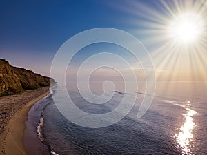 Aerial panoramic view of sunset over sea. Nothing but sky, clouds and water. Beautiful serene scene