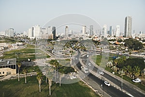 Aerial panoramic view of Tel Aviv. City buildings, well planned transport junction of highways, greenary, traffic and skysrapers