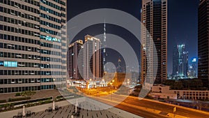 Aerial panoramic view to Dubai downtown and difc skyscrapers all night timelapse.