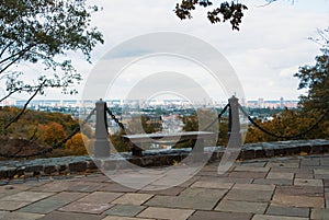 Aerial panoramic view to Kyiv with a bench at the foreground on