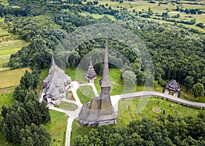 Aerial panoramic view of traditional ancient Maramures wooden orthodox church in Transylvania with highest wooden