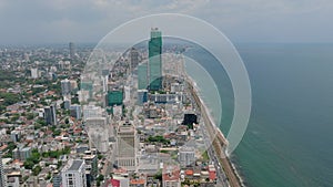 Aerial panoramic view of urban neighbourhood at ocean coast. Busy thoroughfare on waterfront. Skyscraper under