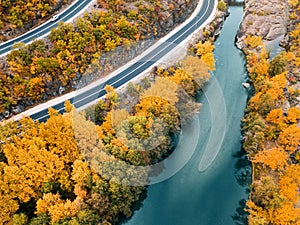 panoramic view of Venetikos river and serpentine highway road in autumn forest in Balkan Greece. Nature park background