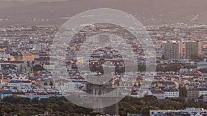 Aerial panoramic view of Vienna city with skyscrapers, historic buildings and a riverside promenade timelapse in Austria