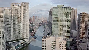 Aerial of the Pasig River and luxury condominiums surrounding both sides of the riverbank. An important waterway in Metro Manila