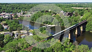 Aerial of a passenger train with Paris, Canada in background 4K