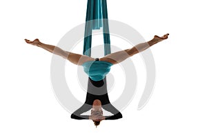 Aerial performer hanging on silk in symmetric pose