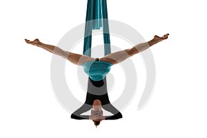 Aerial performer hanging on silk in symmetric pose photo