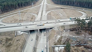 Aerial perspective of interstate commuter traffic crossing bridge on clear, early morning. Video. Aerial Footage of