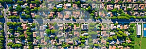 aerial perspective of a peaceful suburban neighborhood, with houses, parks, and tree-lined streets. Generative AI