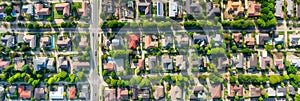 aerial perspective of a peaceful suburban neighborhood, with houses, parks, and tree-lined streets. Generative AI