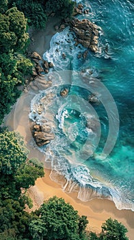 An aerial perspective of a sandy beach meeting the ocean, showcasing the coastline and waves rolling in