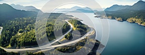 Aerial perspective of a winding section of the Sea to Sky Highway, showcasing the road's integration with the