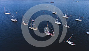 Aerial photo of bay with floating sailing yacht fleet in marina during yachting regatta race