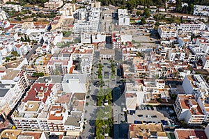 Aerial photo of the beautiful island of Ibiza in Spain showing a top down view of the street and beach with hotel complexes and