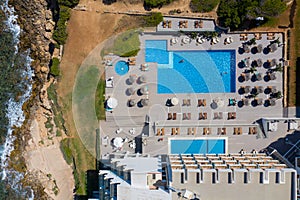 Aerial photo of the beautiful island of Ibiza in Spain showing a top down view of the street and beach with hotel complexes and