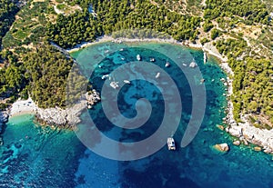 Aerial photo of boats moored at beautiful Velo Borce beach on Hvar island in Croatia