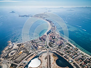 Aerial photo of buildings, villas and the beach on a natural spit of La Manga between the Mediterranean and the Mar Menor,