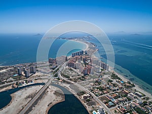 Aerial photo of buildings, villas and the beach on a natural spit of La Manga between the Mediterranean and the Mar Menor,