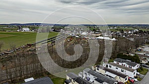 Aerial photo capturing a lively rural community with residential areas, agricultural machinery