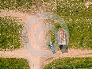 Aerial photo of convertible car parked on the dirt road