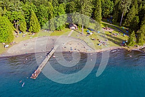 Aerial photo of Cultus Lake in Chilliwack, B.C. while people are enjoying the summer activities at the lakeshore and doing