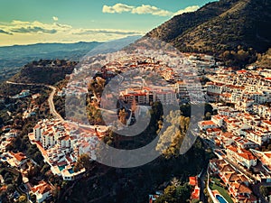 Aerial photo distant view charming Mijas pueblo, typical Andalusian white-washed mountain village