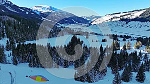 Aerial photo with drone of mountain landscape and balloon in Tannheimer Tal in winter