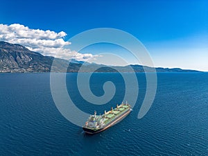 Aerial photo of huge bulk carrier tanker anchored in deep blue Aegean sea