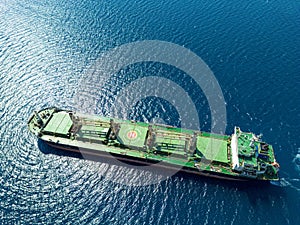 Aerial photo of huge bulk carrier tanker anchored in deep blue Aegean sea