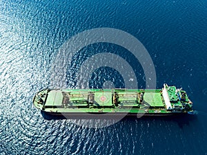 Aerial photo of huge bulk carrier tanker anchored in deep blue Aegean sea