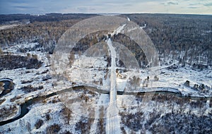 Aerial photo of Koen river and road bridge under ice and snow. Beautiful winter landscape
