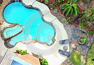 An aerial photo of a lagoon swimming pool and rock deck