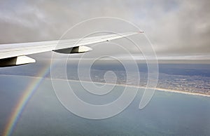 Aerial photo of the landscape and Japan coast around the Tokyo bay stretching all the way to the horizon during rainbow